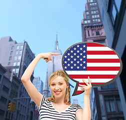 Image showing smiling woman with text bubble of american flag