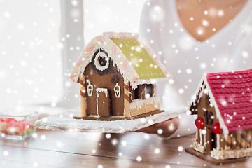 Image showing close up of woman showing gingerbread house