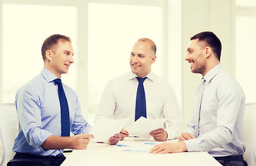 Image showing smiling businessmen with papers in office