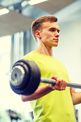 Image showing man doing exercise with barbell in gym