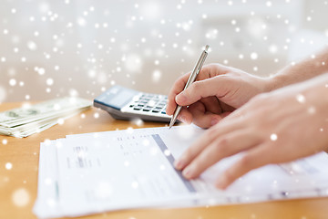 Image showing close up of man with papers doing tax report