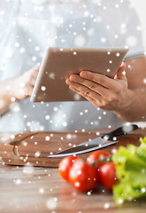 Image showing closeup of man reading recipe from tablet pc