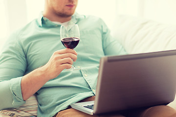 Image showing close up of man with laptop and wine glass