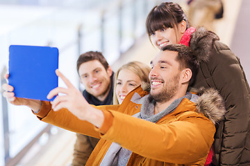 Image showing happy friends with tablet pc on skating rink