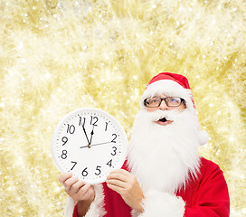 Image showing man in costume of santa claus with clock