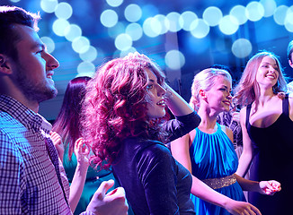 Image showing smiling friends dancing in club