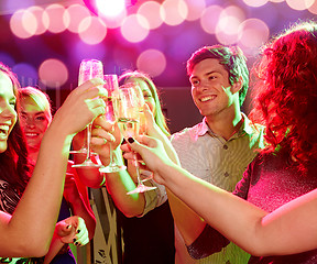 Image showing smiling friends with glasses of champagne in club