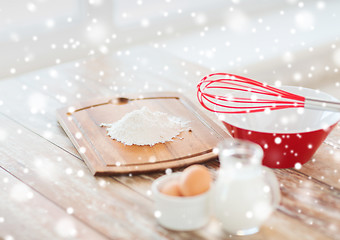 Image showing close up of milk jug, eggs, whisk and flour