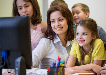 Image showing group of kids with teacher and computer at school