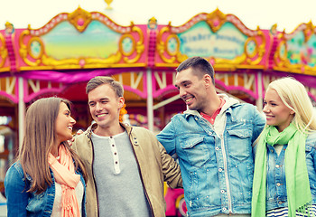 Image showing group of smiling friends in amusement park