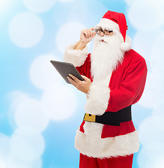 Image showing man in costume of santa claus with tablet pc