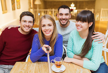 Image showing group of friends taking picture with selfie stick