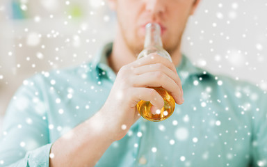 Image showing close up of man drinking beer at home