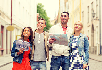 Image showing group of smiling friends with city guide and map