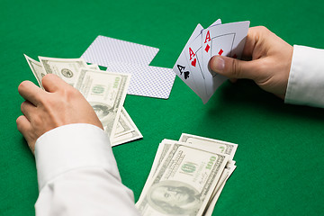 Image showing poker player with cards and money at casino