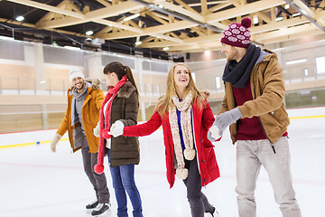 Image showing happy friends on skating rink