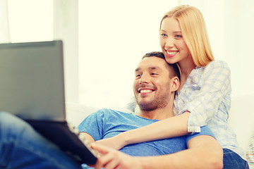 Image showing smiling happy couple with laptop at home