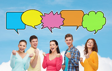 Image showing group of smiling teenagers showing triumph gesture