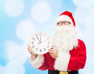 Image showing man in costume of santa claus with clock