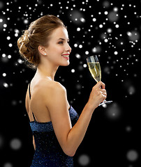 Image showing smiling woman holding glass of sparkling wine