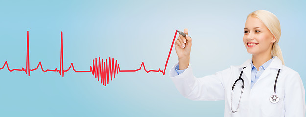 Image showing smiling female doctor drawing heartbeat cardiogram