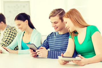 Image showing smiling students with tablet pc at school