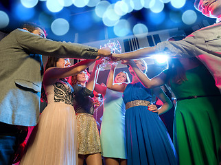 Image showing smiling friends with glasses of champagne in club