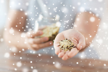 Image showing female emptying jar with white and wild black rice