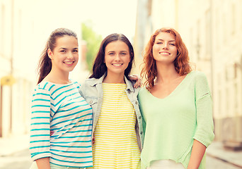 Image showing smiling teenage girls with on street