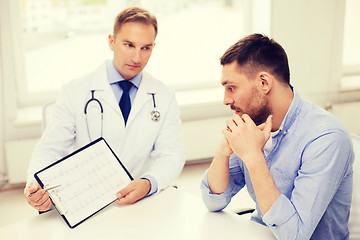 Image showing doctor with clipboard and patient in hospital