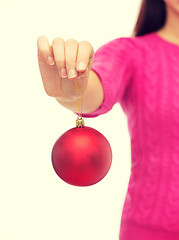 Image showing close up of woman in sweater with christmas ball