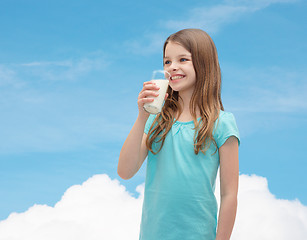 Image showing smiling little girl drinking milk out of glass