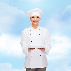 Image showing smiling female chef with tablet pc computer