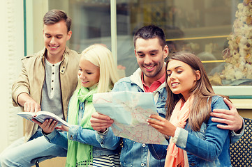 Image showing group of friends with guide and map exploring town