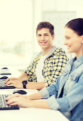 Image showing smiling boy with girl in computer class at school