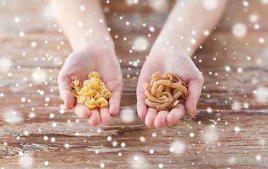 Image showing close up of hands with different pasta variations