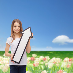 Image showing smiling little girl with blank arrow pointing up