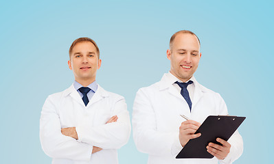 Image showing smiling doctors in white coats with clipboard