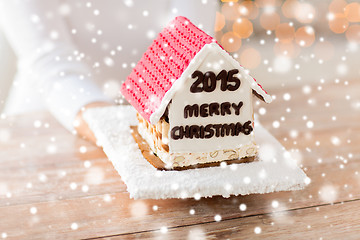 Image showing close up of woman showing gingerbread house