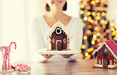 Image showing close up of woman showing gingerbread house