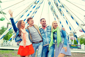 Image showing group of smiling friends waving hands