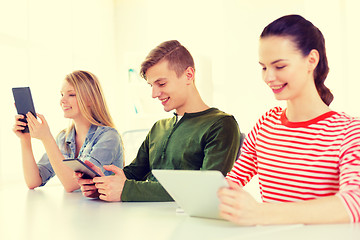 Image showing smiling students with tablet pc at school