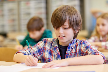 Image showing group of school kids writing test in classroom