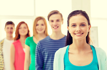 Image showing smiling students with teenage girl in front