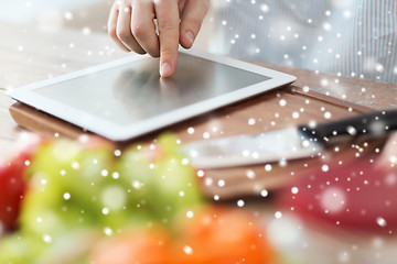 Image showing closeup of man reading recipe from tablet pc