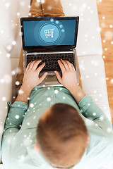 Image showing close up of man working with laptop at home