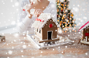 Image showing close up of woman making gingerbread houses