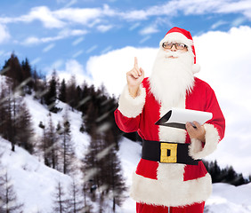 Image showing man in costume of santa claus with notepad