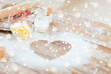 Image showing heart of flour on wooden table at home