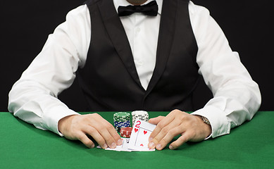 Image showing poker player with cards and chips at casino